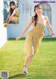 A woman in a yellow dress is posing for a magazine.