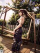 A woman standing on a wooden deck next to a swing.